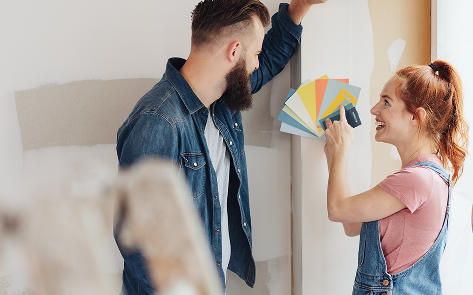 Mortgage-960x600 – Capital Bank A young couple is in their home and looking at paint swatches